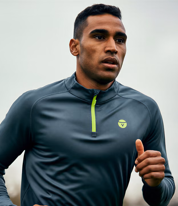 Man running outdoors in a dark training top