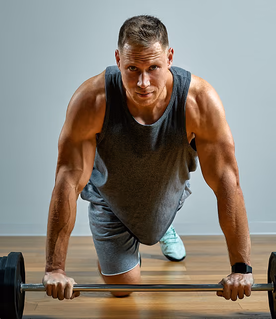 Man doing a push-up with his hands on a barbell